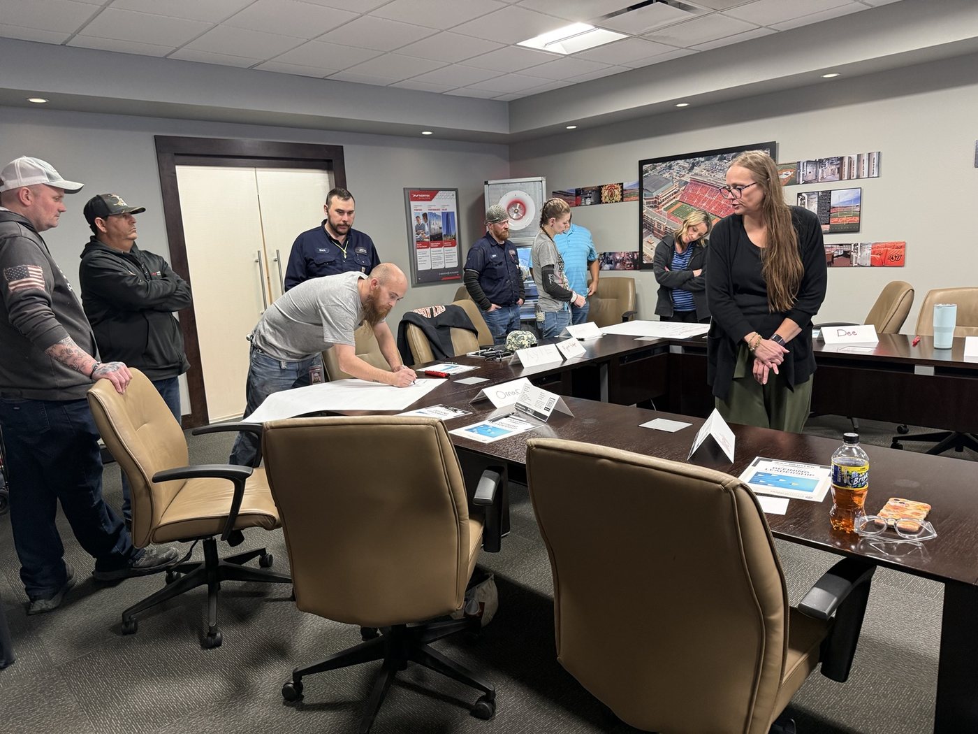 Melody Edwards facilitating an interactive professional development activity with participants around a conference table